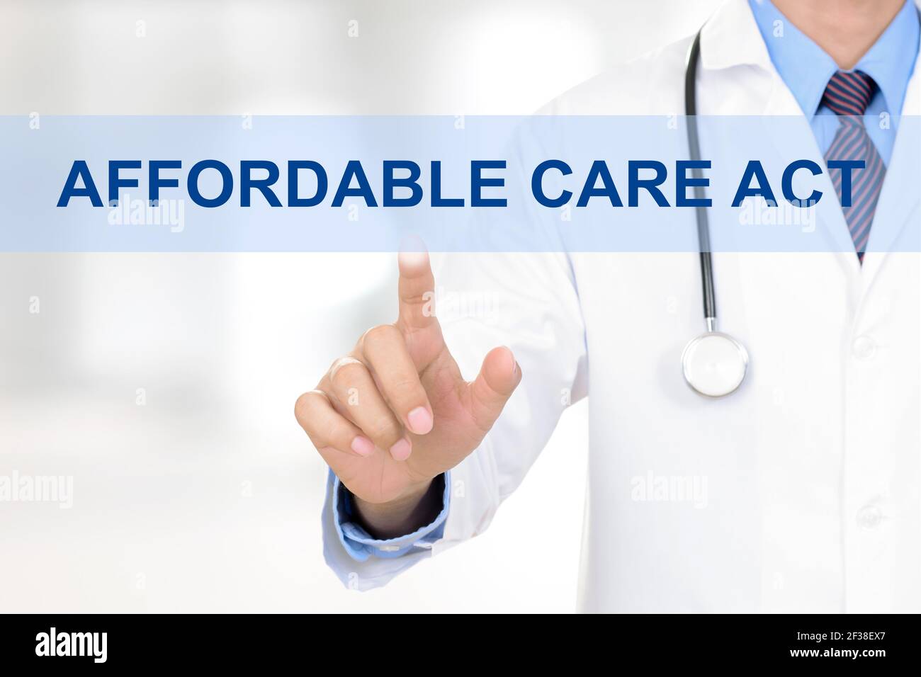 Doctor hand touching AFFORDABLE CARE ACT sign on virtual screen Stock Photo