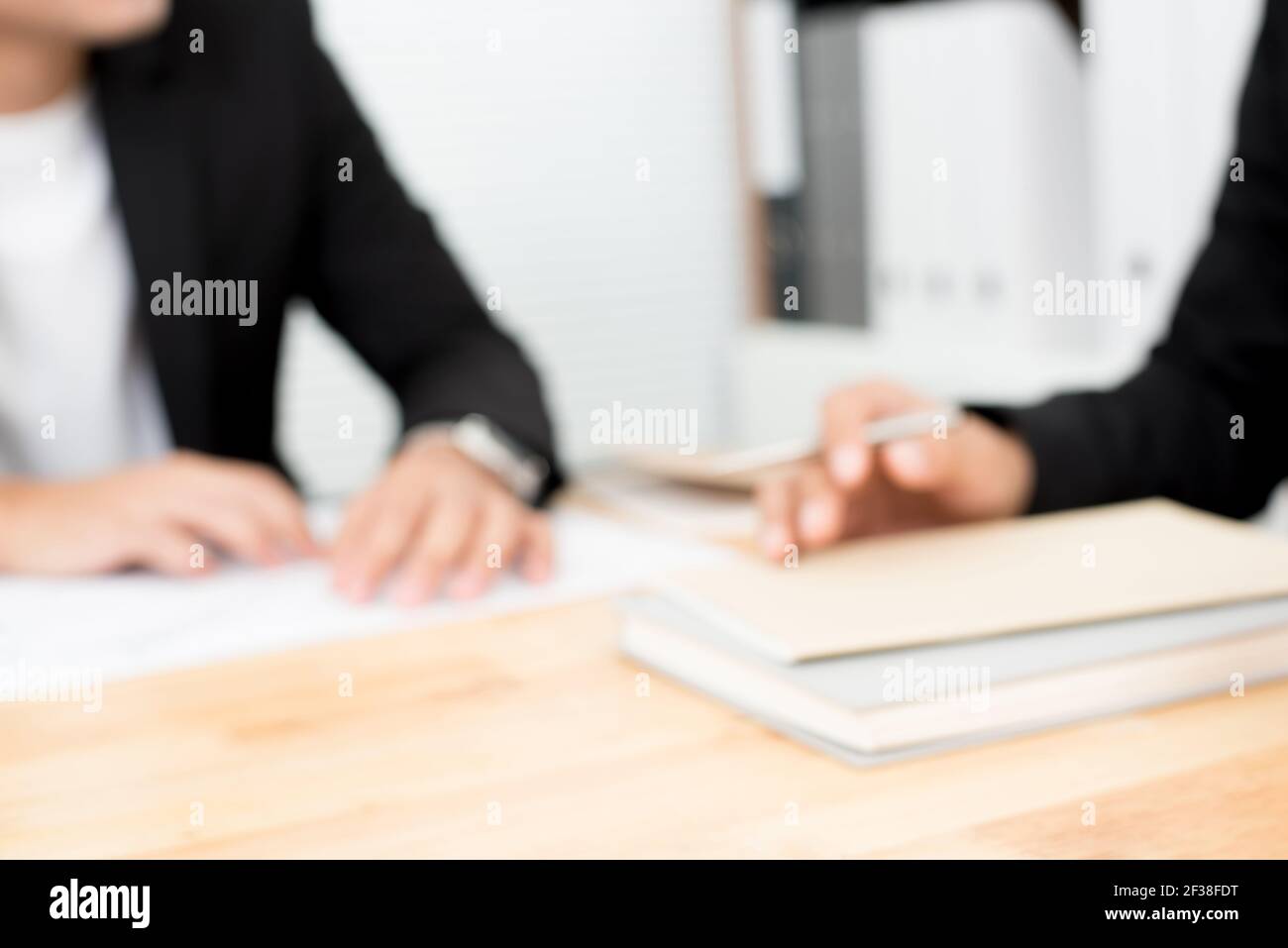 Blurred hands of businessmen on conference (meeting) table Stock Photo