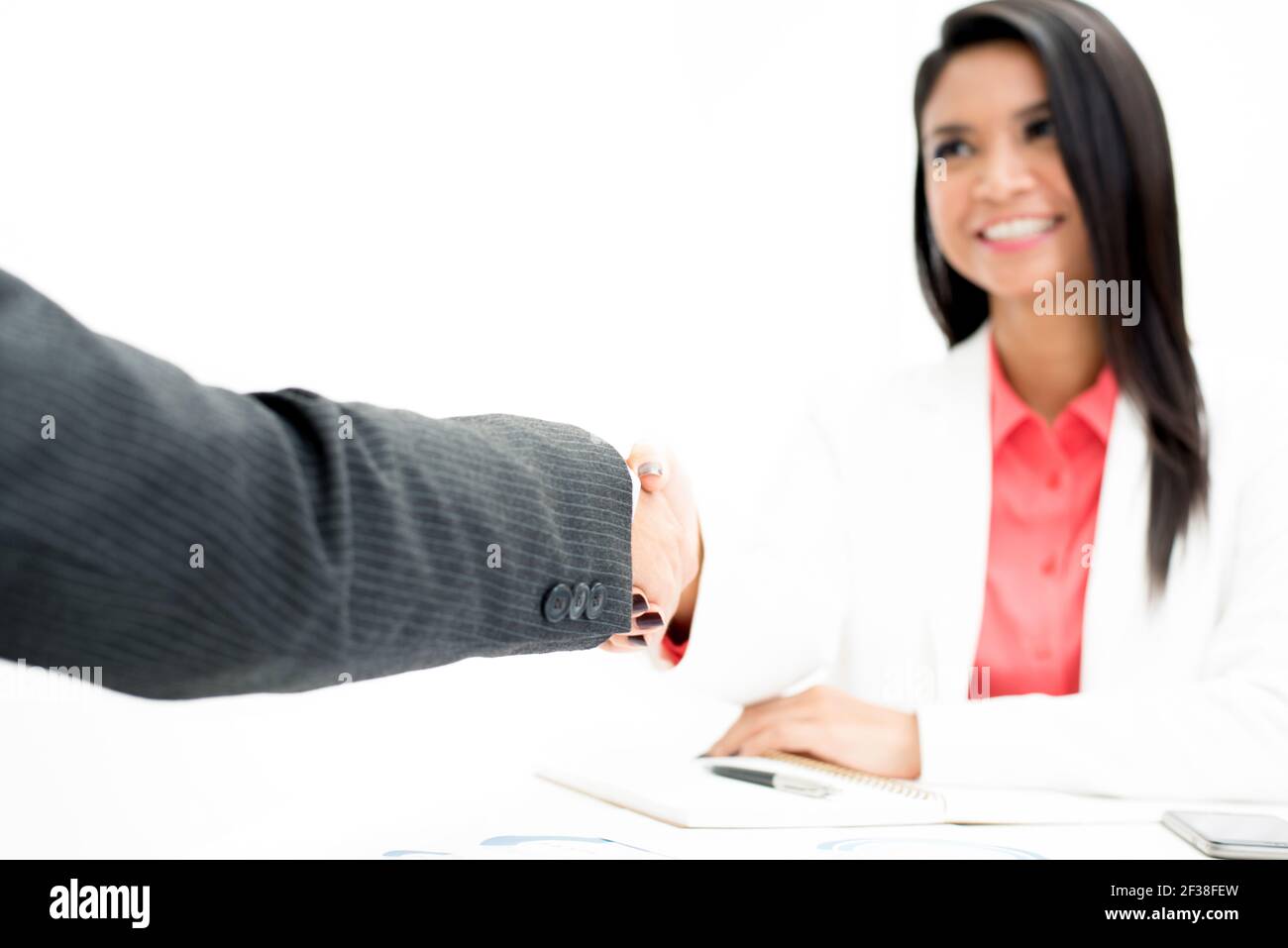 Hand of businessman making handshake with a businesswoman Stock Photo