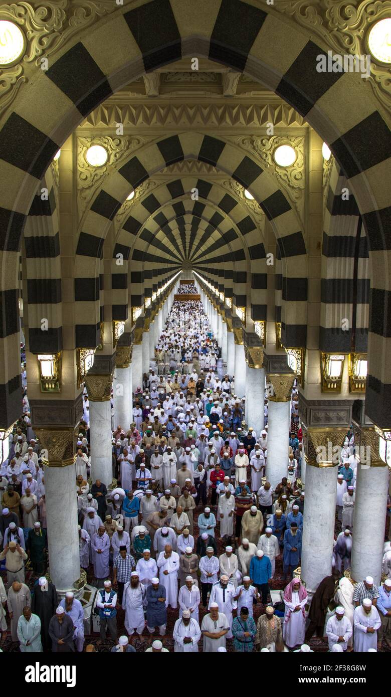 Muslims praying in Nabawi Mosque. Interior of Masjid Nabawi. Fajr Pray. Medinah - Saudi Arabia: 2 September 2018 Stock Photo