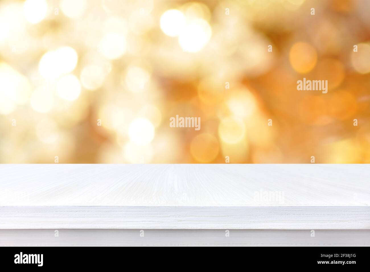 White wood table top on gold bokeh abstract background - can be used for display or montage your products Stock Photo
