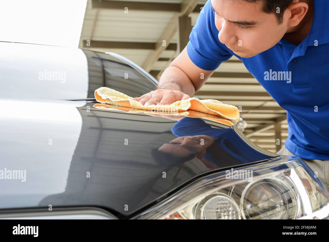 A man cleaning car with microfiber cloth Stock Photo