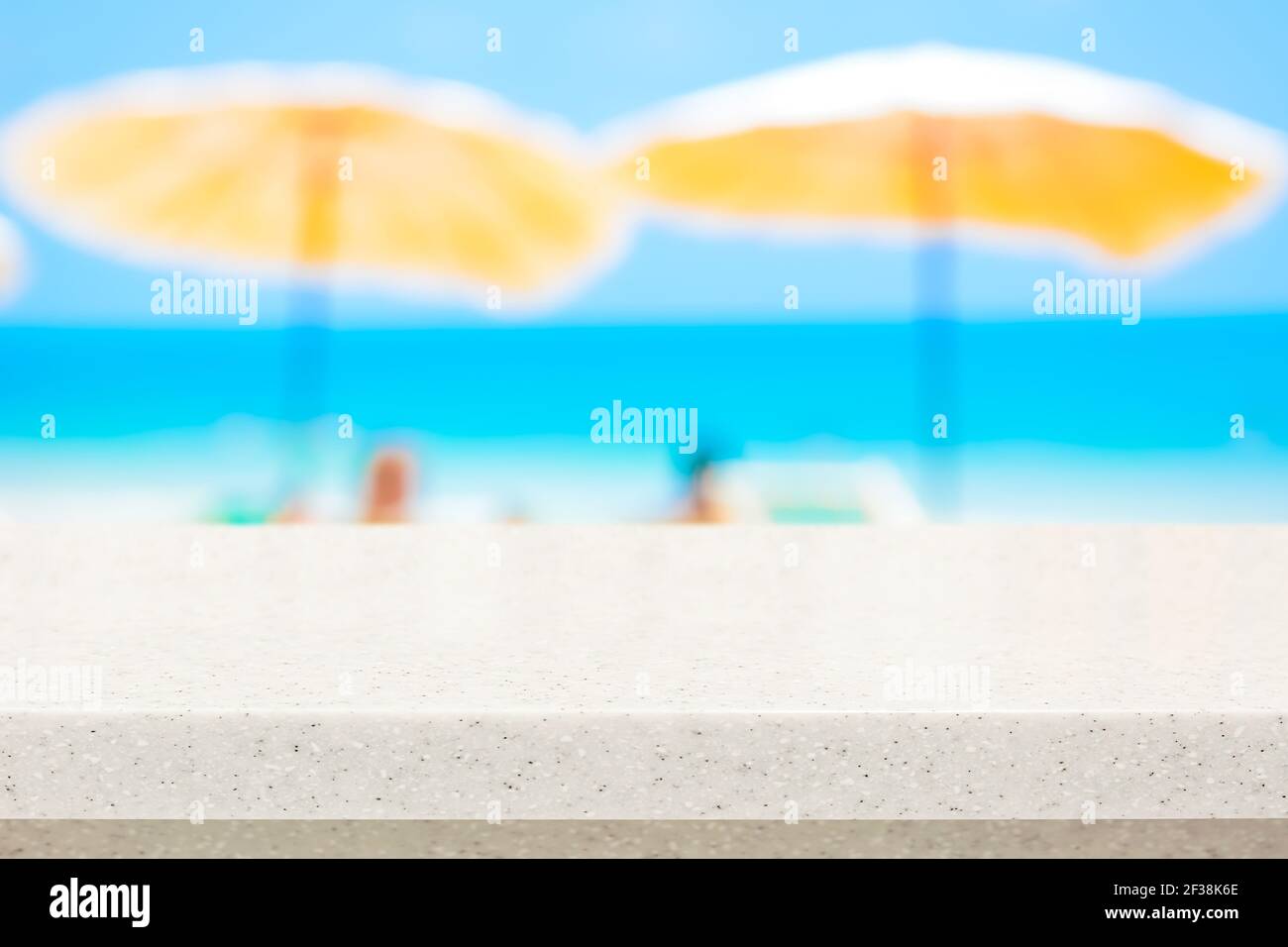 White stone countertop on blurred summer beach background - can be used for display or montage your products Stock Photo