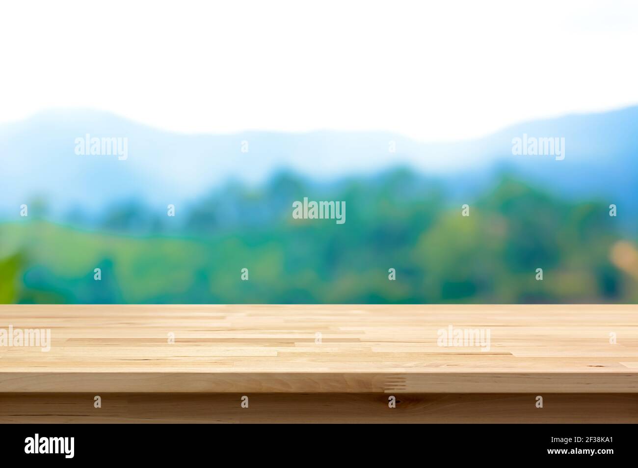 Wood table top on blur mountain background - can be used for display or montage your products Stock Photo