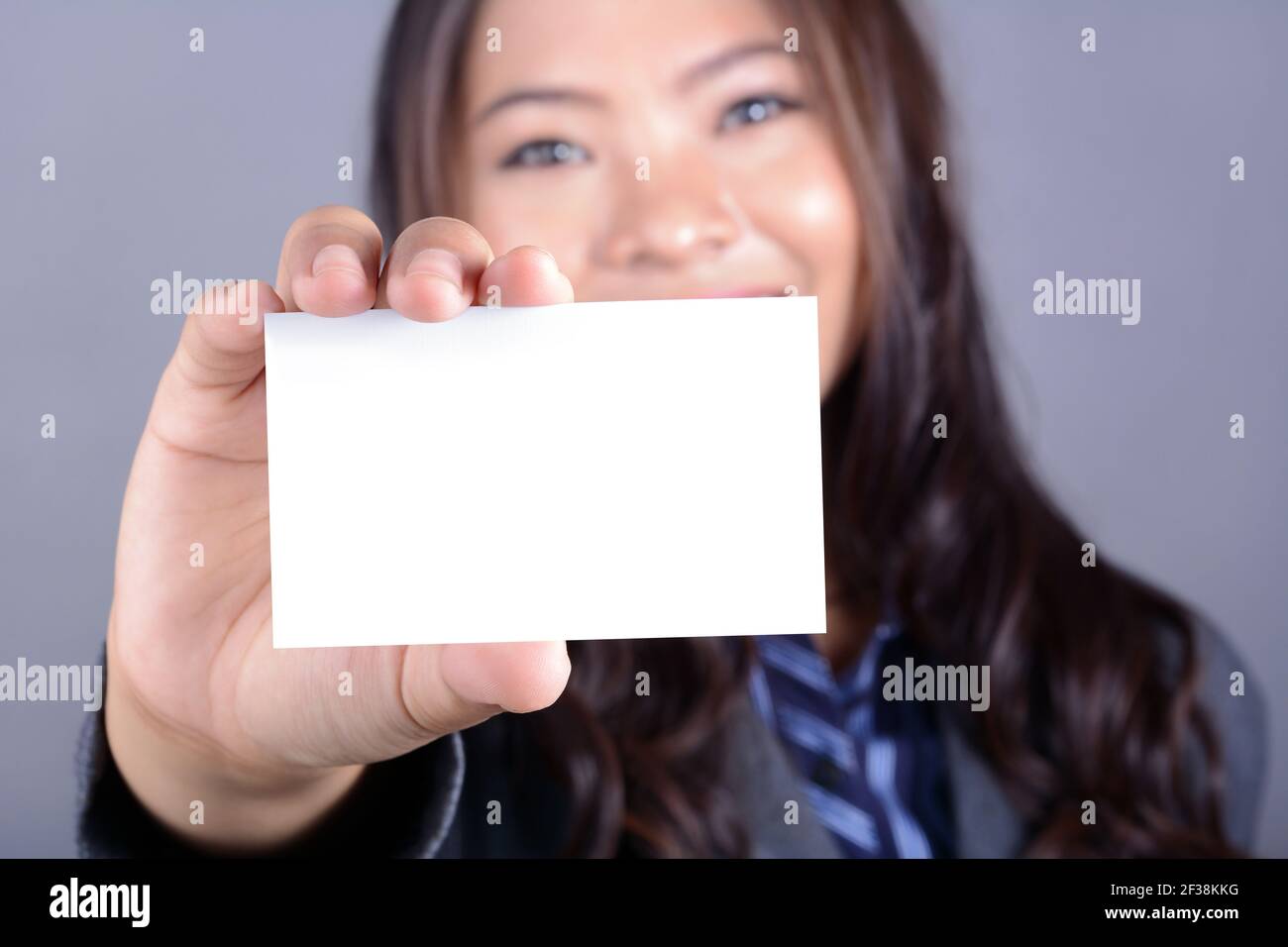 Asian businesswoman holding empty white card Stock Photo
