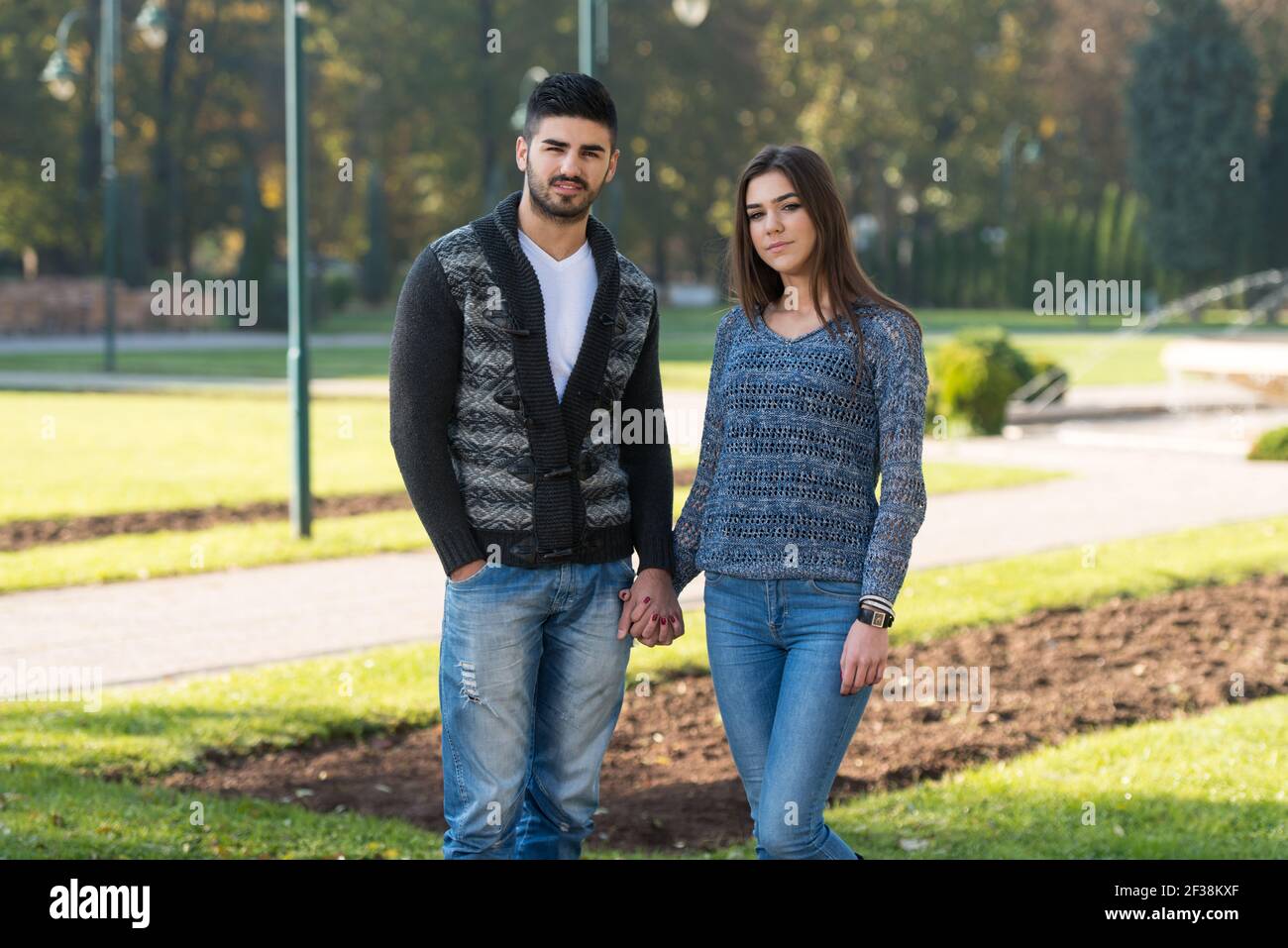 Portrait of a Beautiful Young Couple Relaxing in Park Stock Photo - Alamy