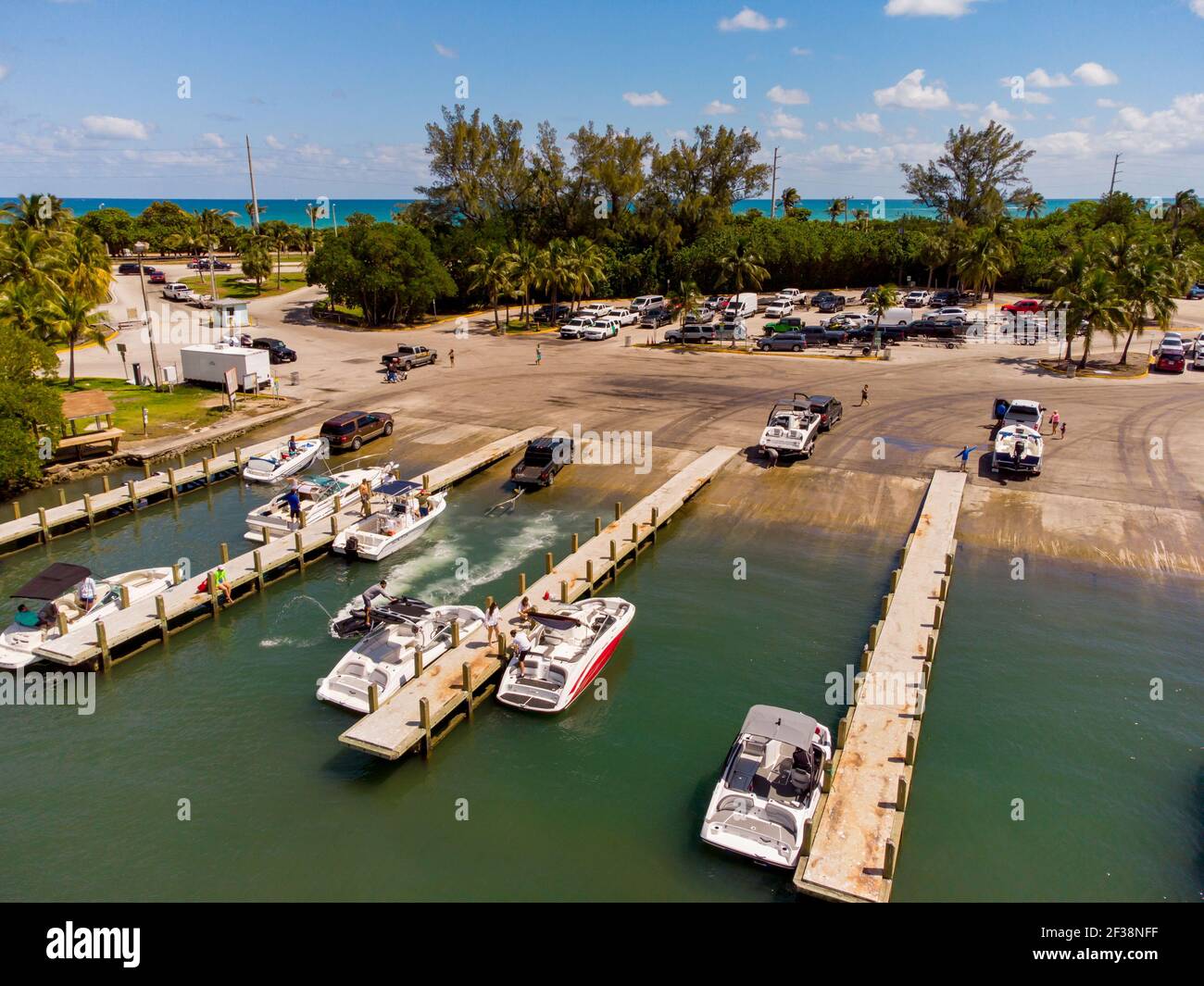 Trucks loading boats down ramp at marina Miami aerial photo Stock Photo ...