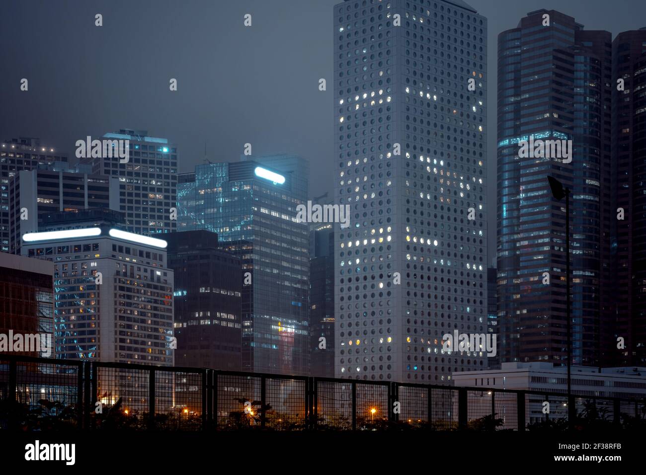 Modern office buildings in Hong Kong at foggy night Stock Photo - Alamy
