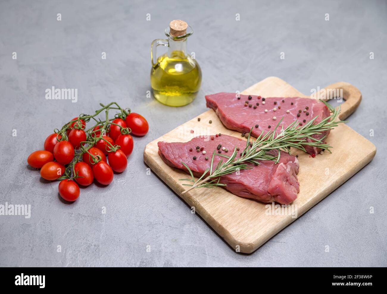 Preparation for grilling, frying meat. Pieces of raw steaks Stock Photo