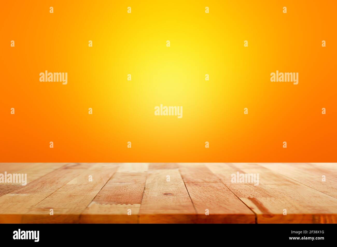Wood table top on gradient orange background - can be used for display