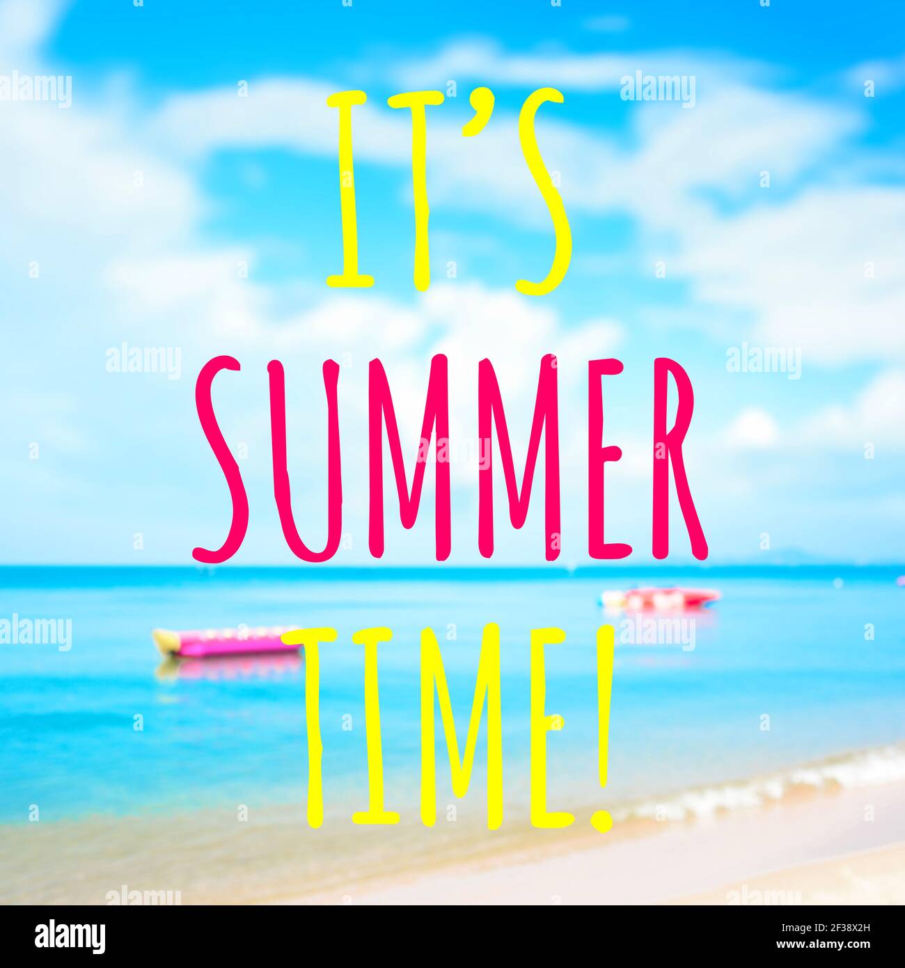 Colorful text, IT'S SUMMER TIME, on blur beach background Stock Photo