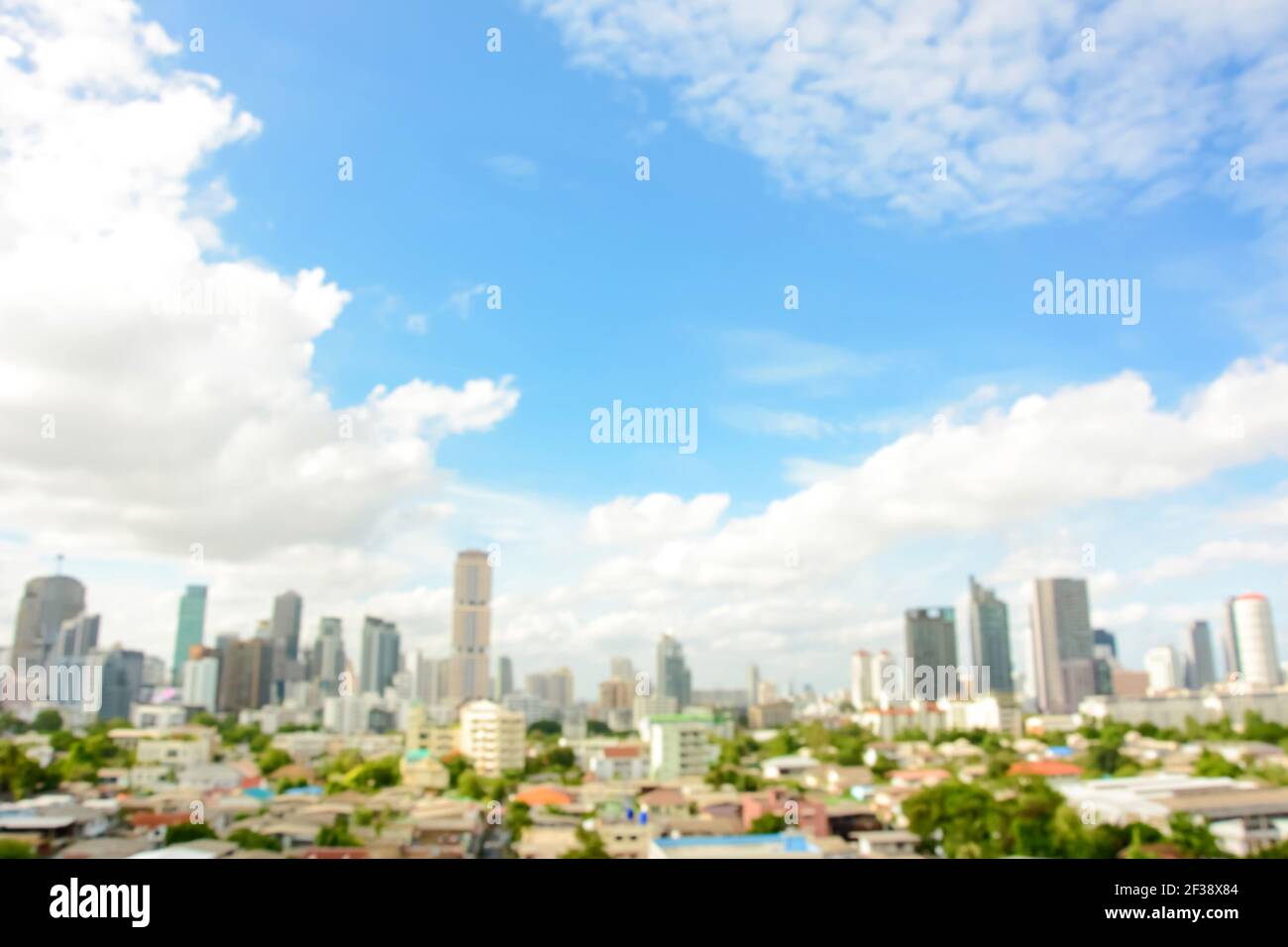 Blurred image of buildings in the city with blue sky and clouds as background - Bankgkok, Thailand Stock Photo