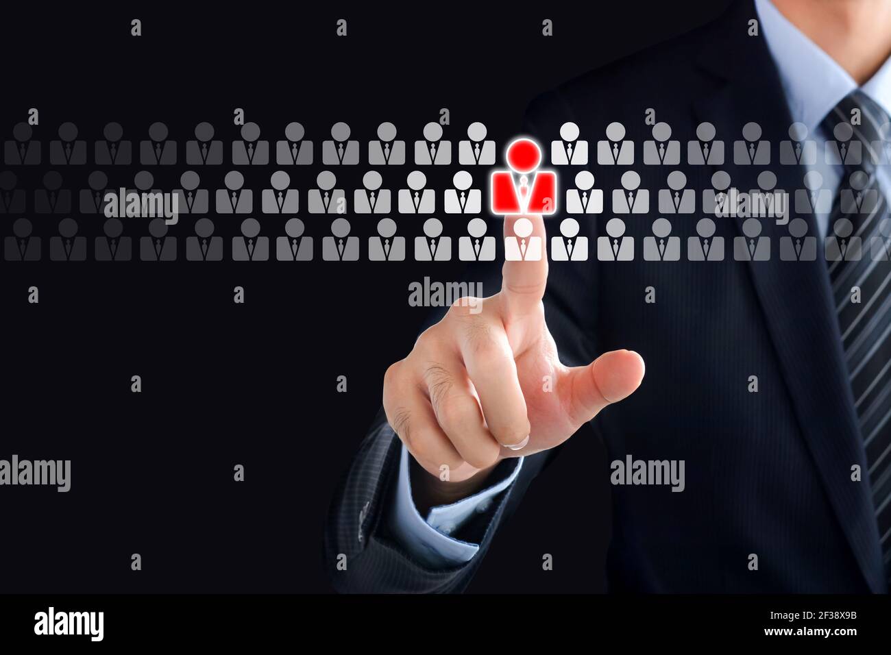 Businessman hand touching red human icon on virtual screen - stand out from the crowd, HR and HRM concepts Stock Photo