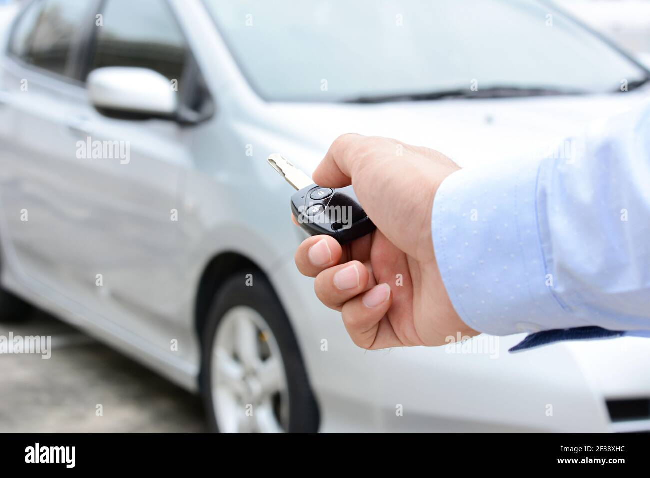 Hand pressing remote control car key Stock Photo Alamy