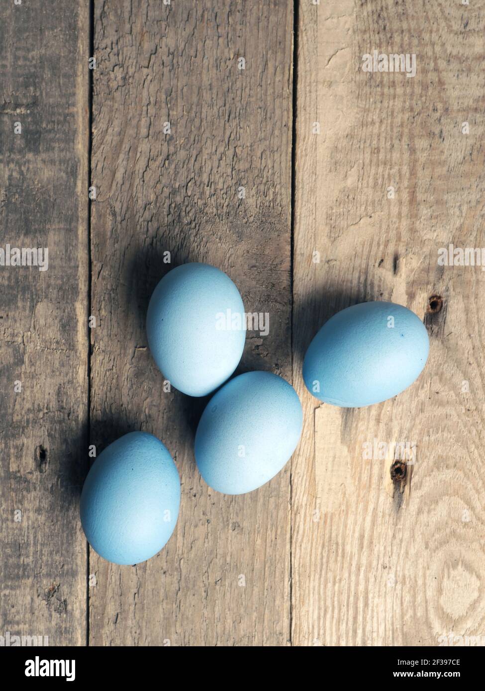Naturally colored organic eggs on a rustic table with space for text, Easter background Stock Photo