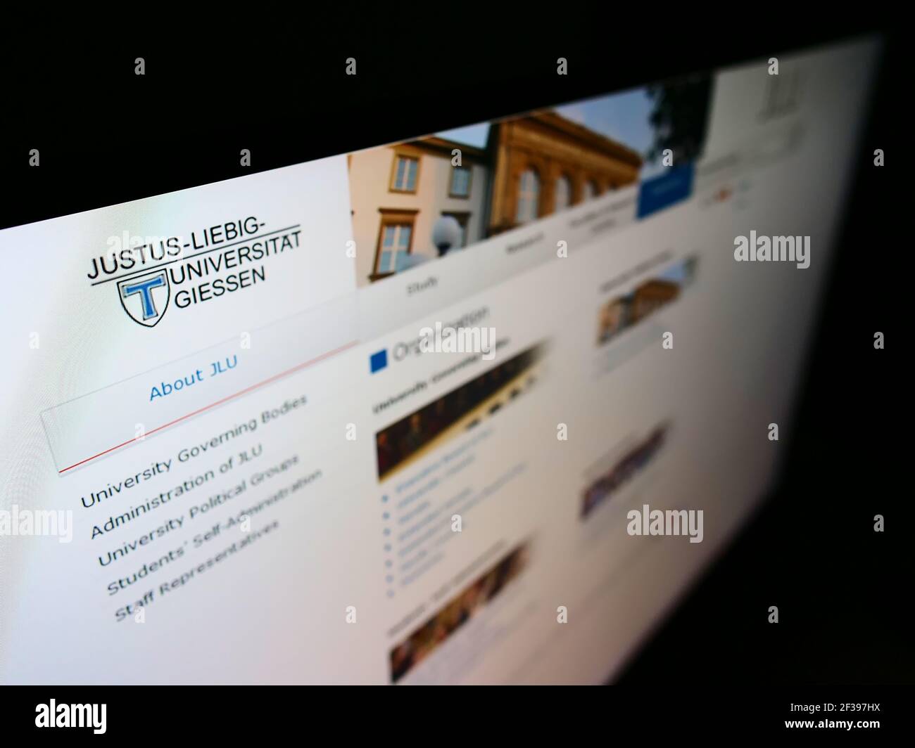 High angle view of website with logo of German education institution Justus Liebig University Giessen on monitor. Focus on top-left of screen. Stock Photo