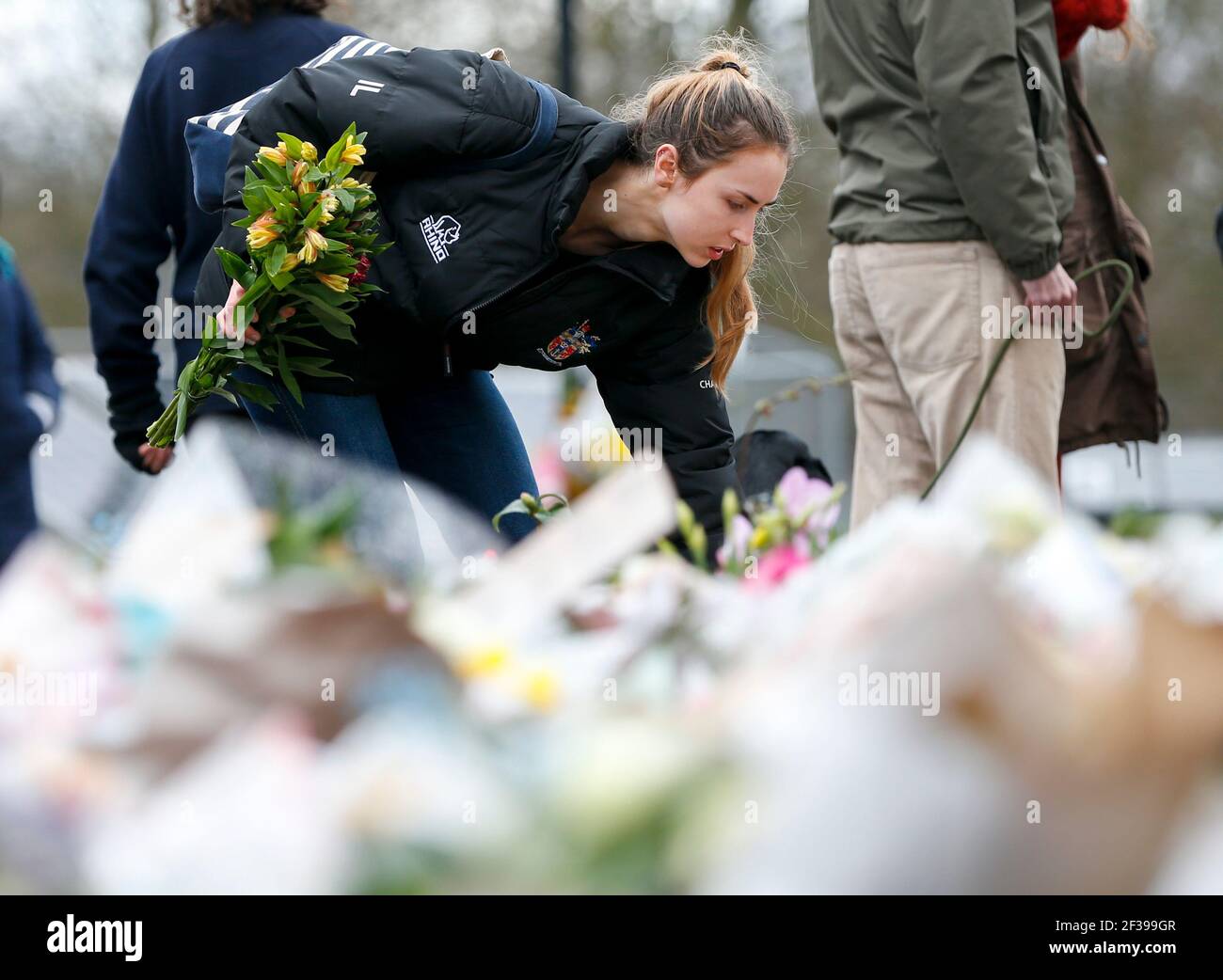 London, UK. 15th Mar, 2021. A woman lays floral tributes at the bandstand on Clapham Common to mourn for Sarah Everard in London, Britain, on March 15, 2021. A serving Metropolitan police officer on March 13 appeared in court in London after being charged with the kidnap and murder of a 33-year-old woman. Wayne Couzens, 48, was arrested after Sarah Everard, a marketing executive, went missing while walking home from a friend's apartment in south London on March 3. Credit: Xinhua/Alamy Live News Stock Photo