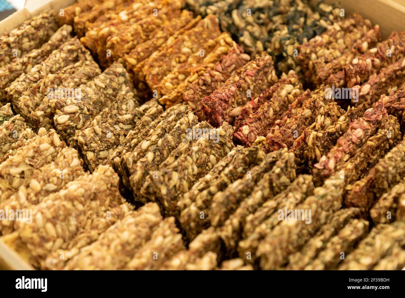 Vegan crackers breadcrisp made with sesame, flax, sunflower, pumpkin and hemp seeds. Raw food background Stock Photo