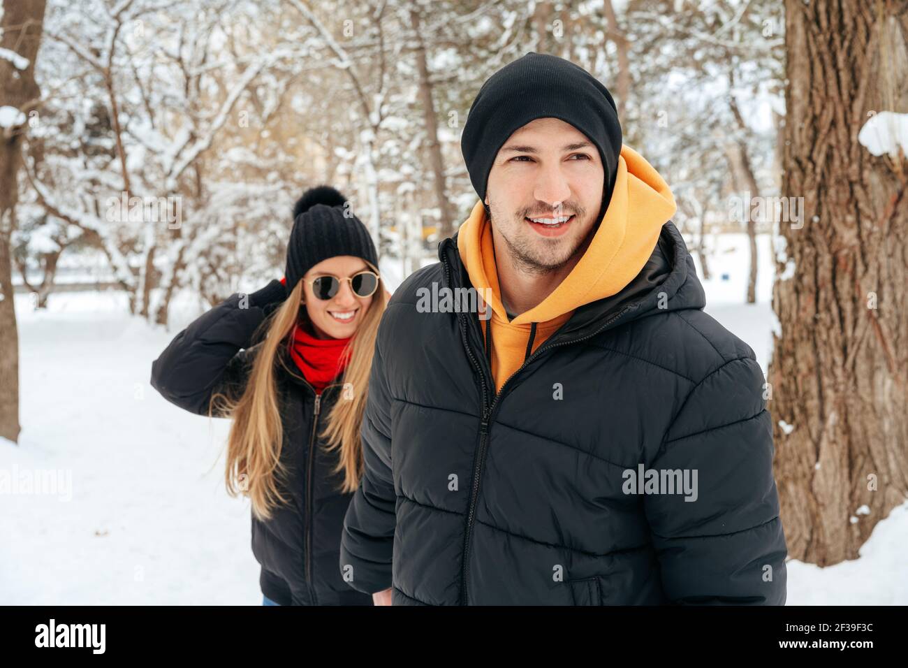 Happy couple hugging and smiling outdoors in snowy park Stock Photo - Alamy
