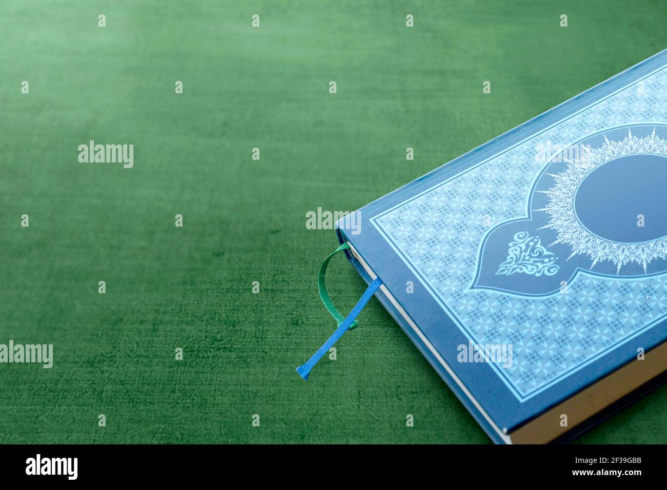 Quran on the green carpet Stock Photo Alamy