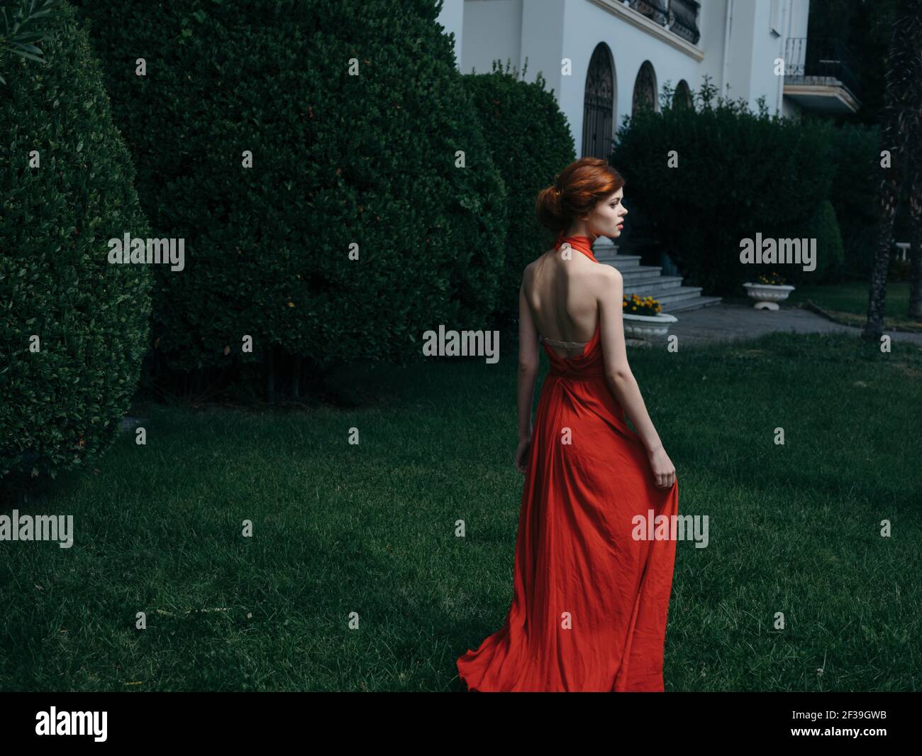 Pretty woman red dress walking luxury model outdoors Stock Photo Alamy