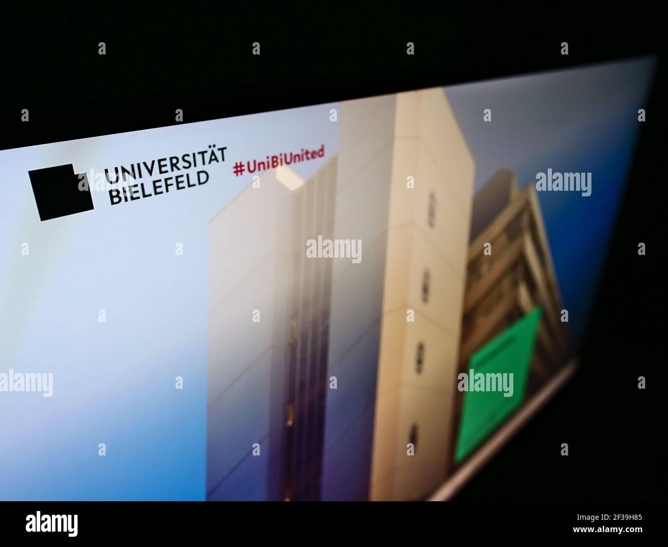 High angle view of website with logo of German university Universität Bielefeld on monitor. Focus on top-left of screen. Unmodified photo. Stock Photo