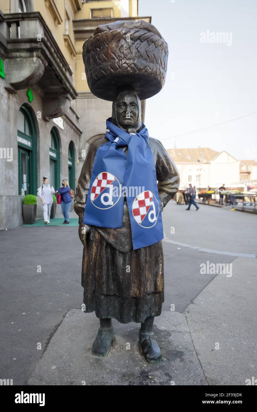 The monument of a saleswoman from old times on Dolac market was covered with Dinamo scarf, before the football match between Dinamo and Krasnodar. Din Stock Photo