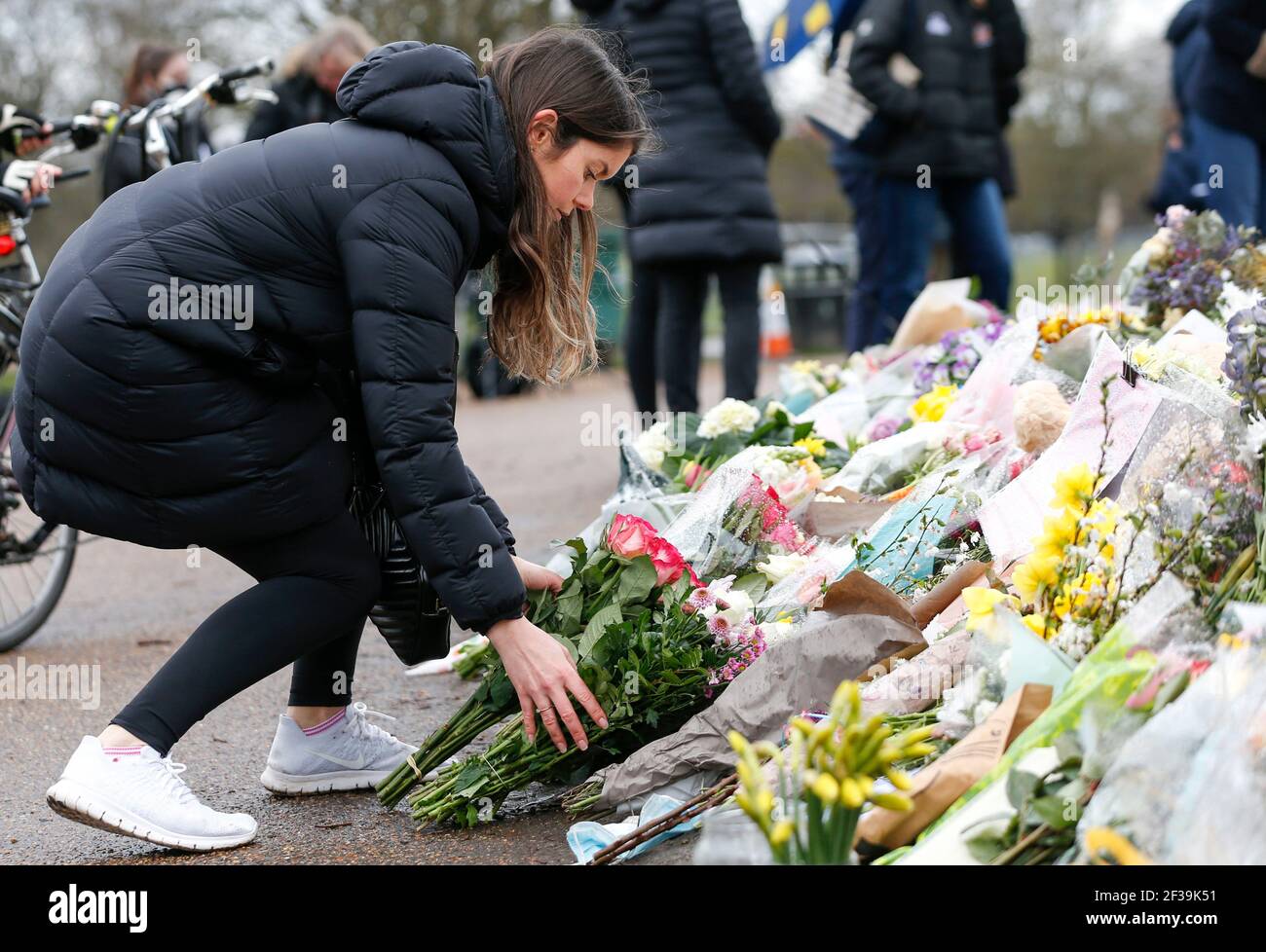 London, UK. 15th Mar, 2021. A woman lays floral tributes at the bandstand on Clapham Common to mourn for Sarah Everard in London, Britain, on March 15, 2021. A serving Metropolitan police officer on March 13 appeared in court in London after being charged with the kidnap and murder of a 33-year-old woman. Wayne Couzens, 48, was arrested after Sarah Everard, a marketing executive, went missing while walking home from a friend's apartment in south London on March 3. Credit: Xinhua/Alamy Live News Stock Photo