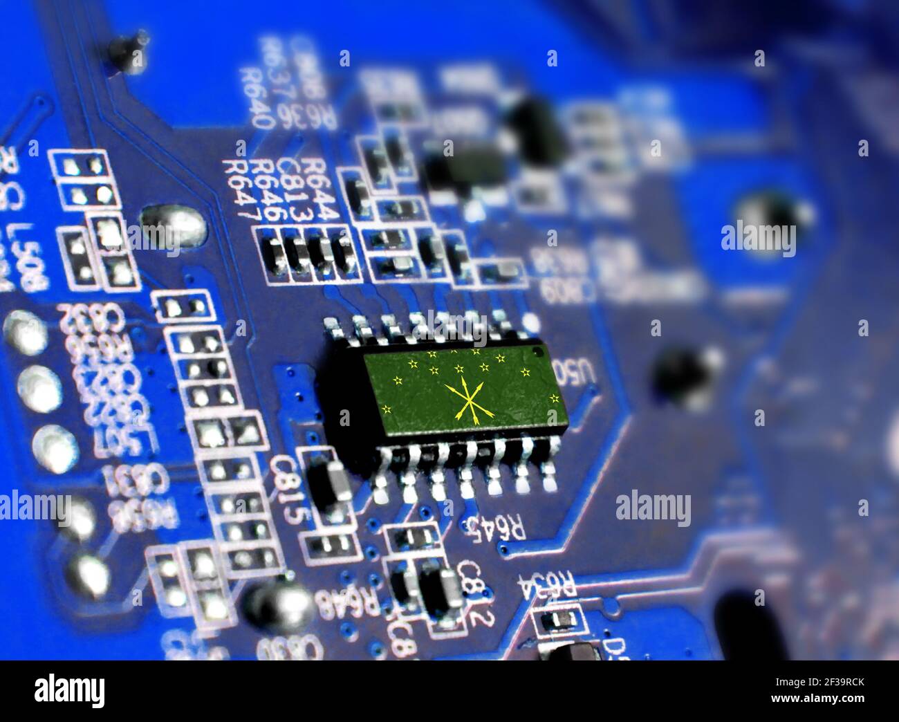 Electronic board with embedded microchip and shown flag of Adygea. The concept of modern computer technologies. Stock Photo