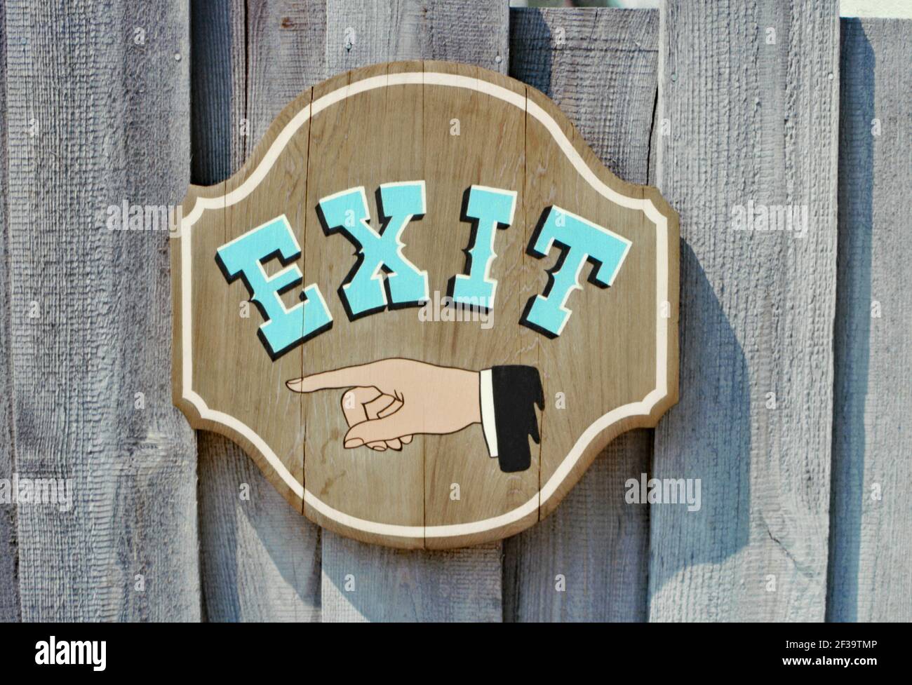 An exit sign at Silver Springs Wild Waters, Silver Springs, Florida, USA in 1980. The finger points the way out. This water park was adjacent to Silver Springs Nature Theme Park. Opened in 1978, it was a small park by today’s standards but it attracted people who enjoyed a more traditional water park experience. It was among the first water parks in the country to have fiberglass flume rides. Wild Waters closed in 2016. This image is from an old American amateur Kodak colour transparency – a vintage 1980s photograph. Stock Photo