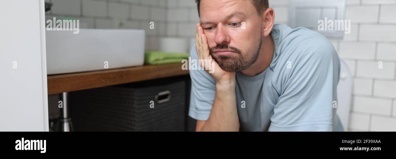 Man sit on toilet with constipation and wait for laxative to take
