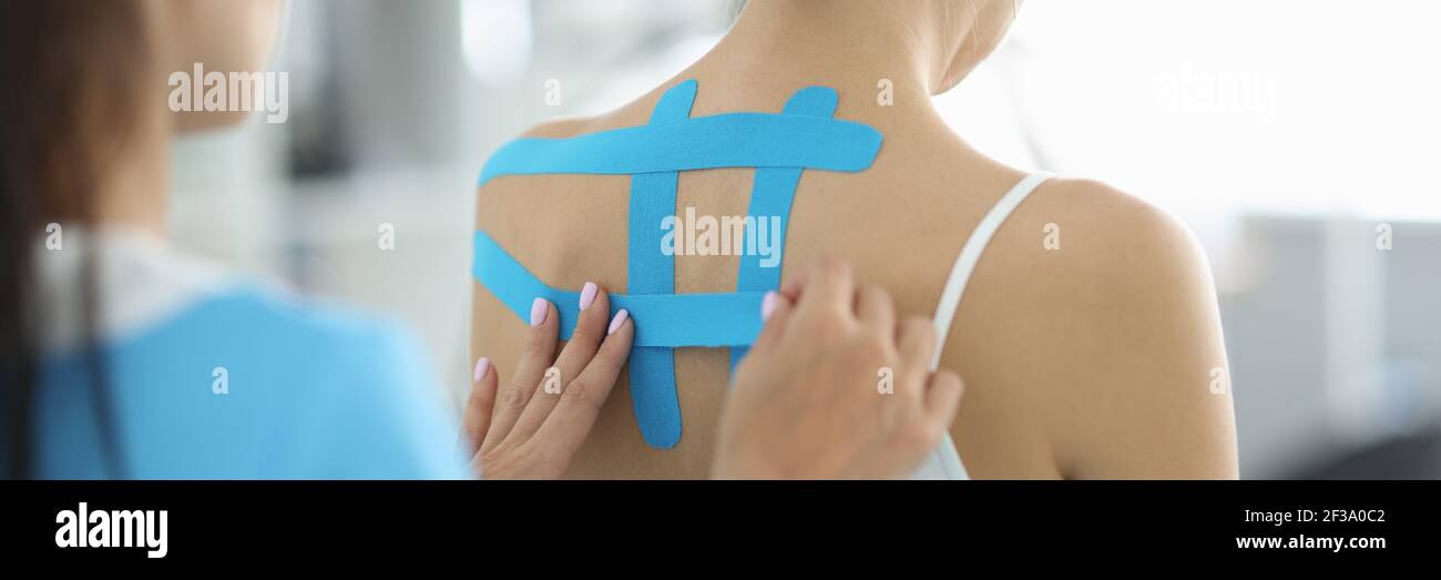 Professional doctor put tapes on patient back for effective treatment