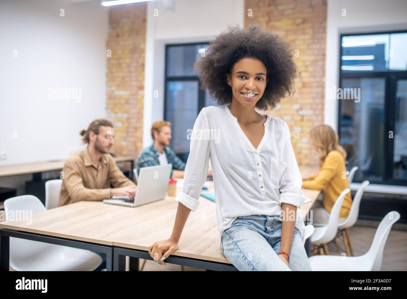 In the office. Young pretty african american girl in the office Stock ...
