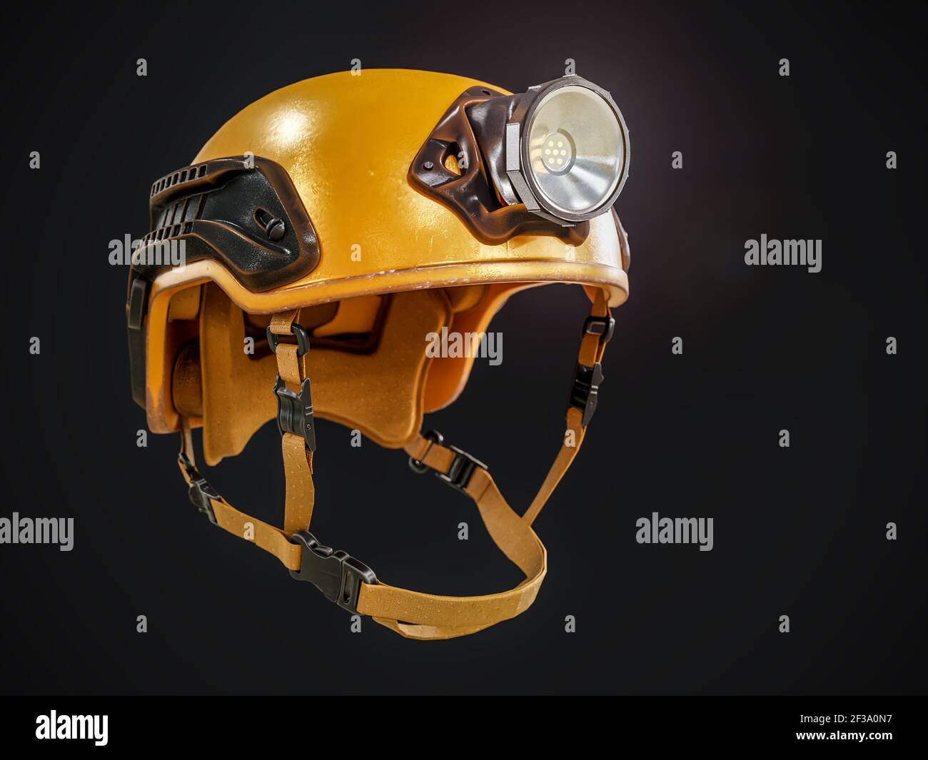 Yellow mountain rescuer hard hat with headlight on black background Stock Photo