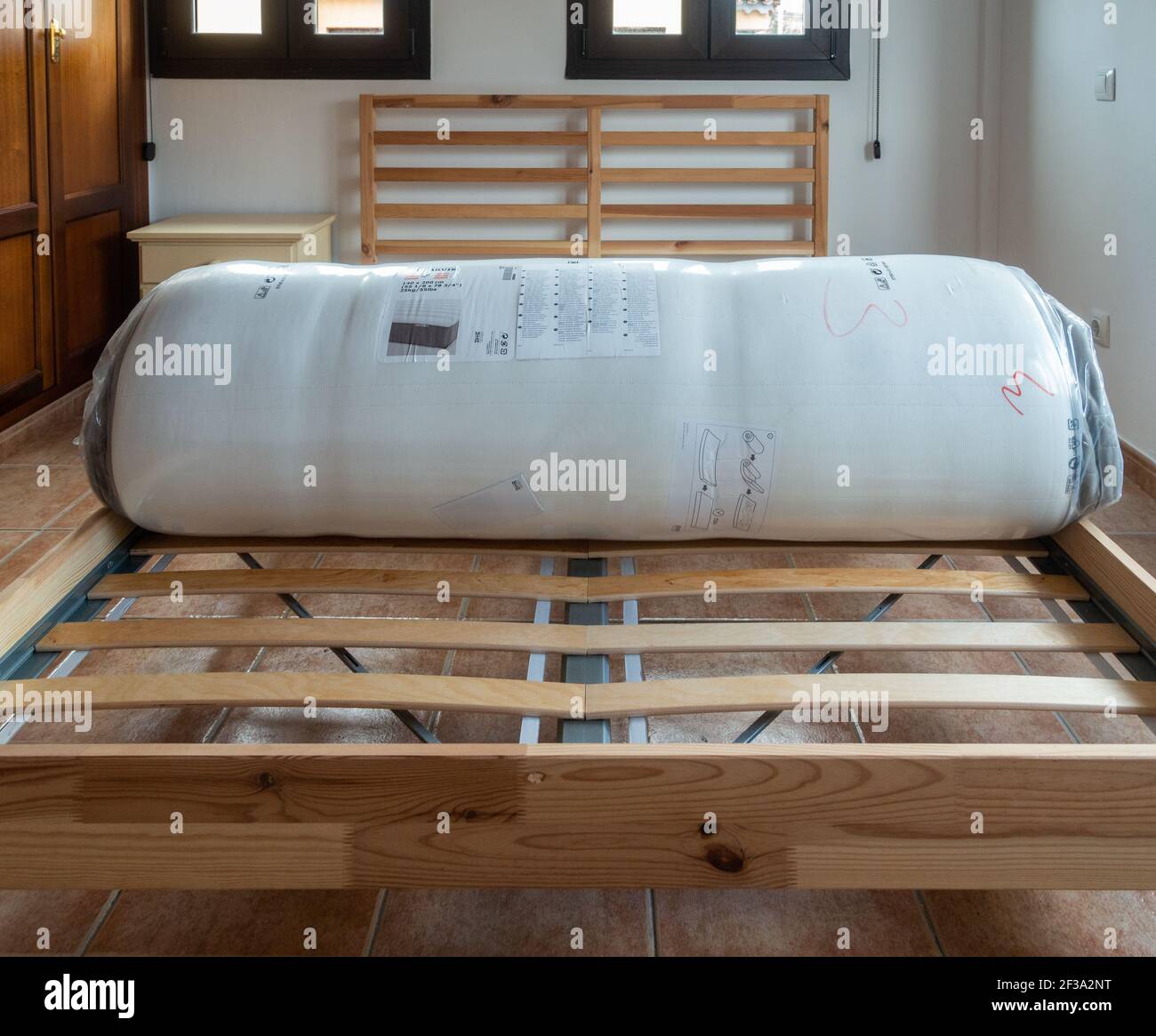 Ikea Hamarvik mattress on Ikea bed frame in house bedroom. Mattress was  delivered rolled and wrapped in thick plastic. Mattress unrolls when opened  Stock Photo - Alamy