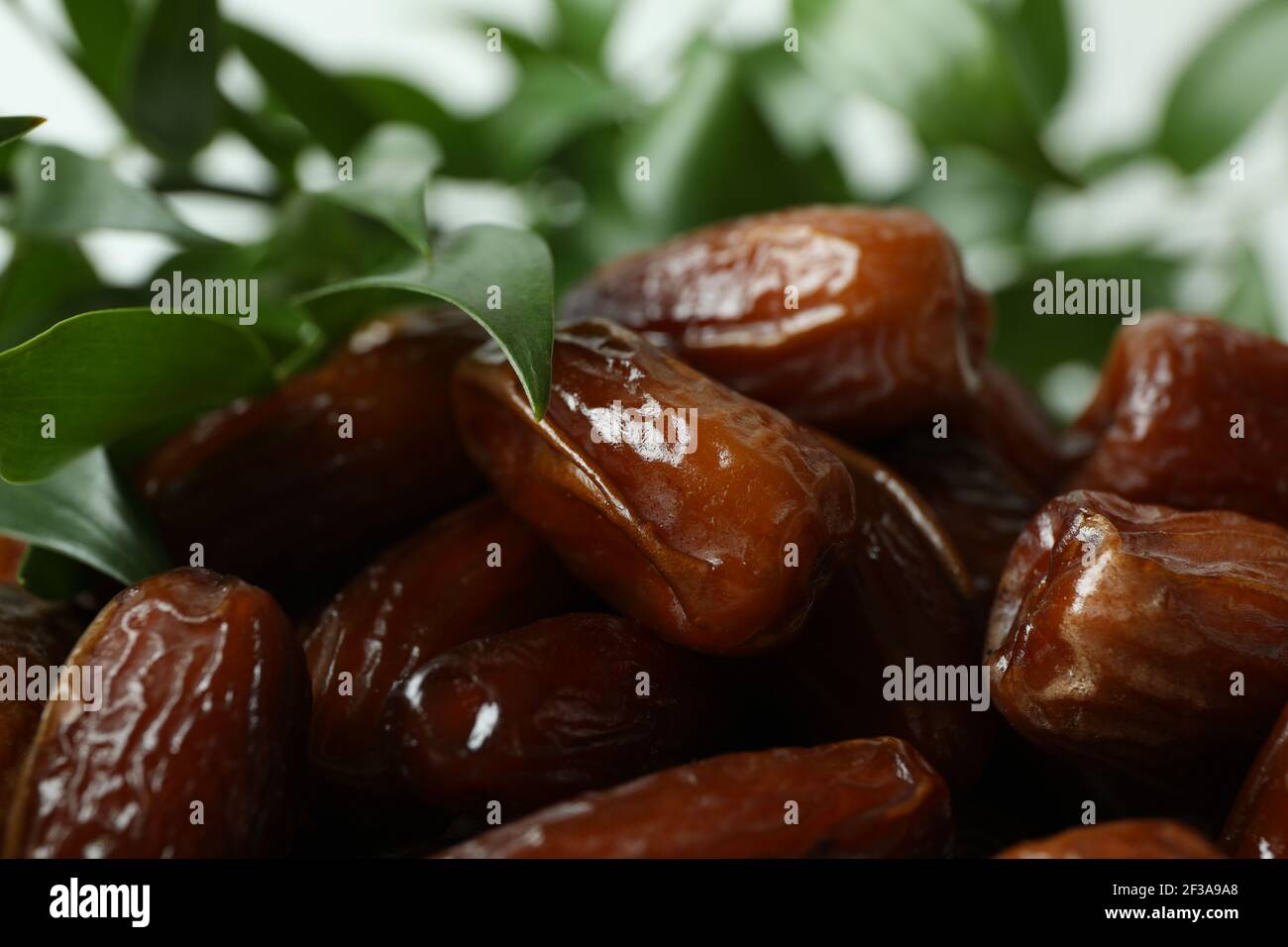 Tasty dried dates and leaves, close up Stock Photo Alamy