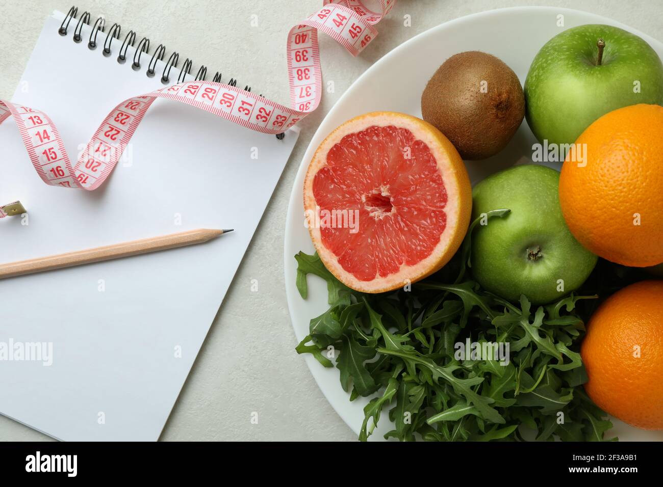 https://c8.alamy.com/comp/2F3A9B1/weight-loss-accessories-on-white-textured-background-close-up-2F3A9B1.jpg