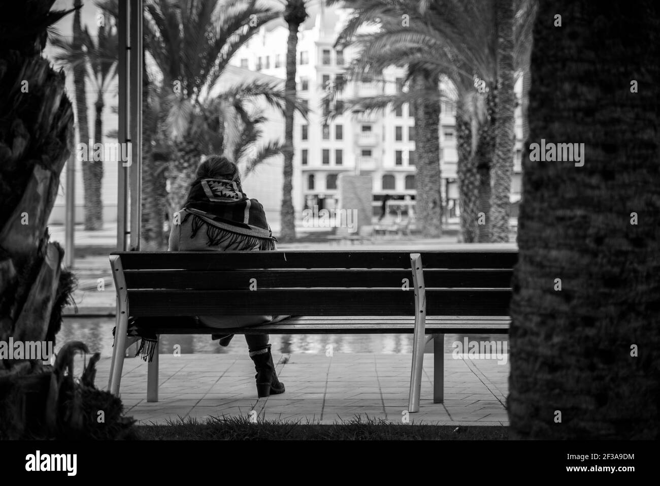 Person sitting on a bench Stock Photo