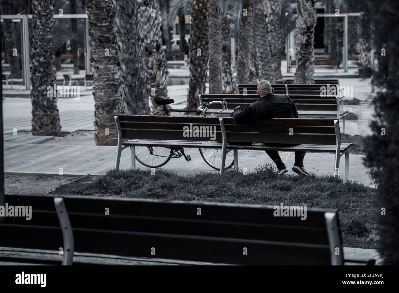 Person sitting on a bench Stock Photo