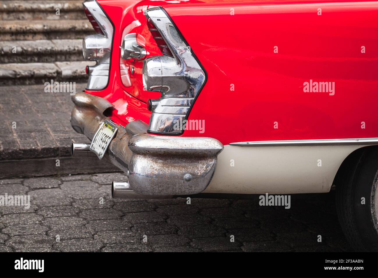 Santo Domingo, Dominican Republic - January 11, 2020: Red white oldtimer. Vintage car fragment. Chromed rear lights and bumper of 1955 Buick Special S Stock Photo