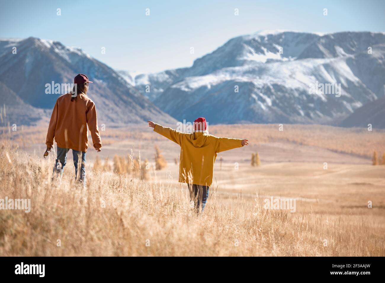Two girls hikers are walking in mountains without backpacks Stock Photo
