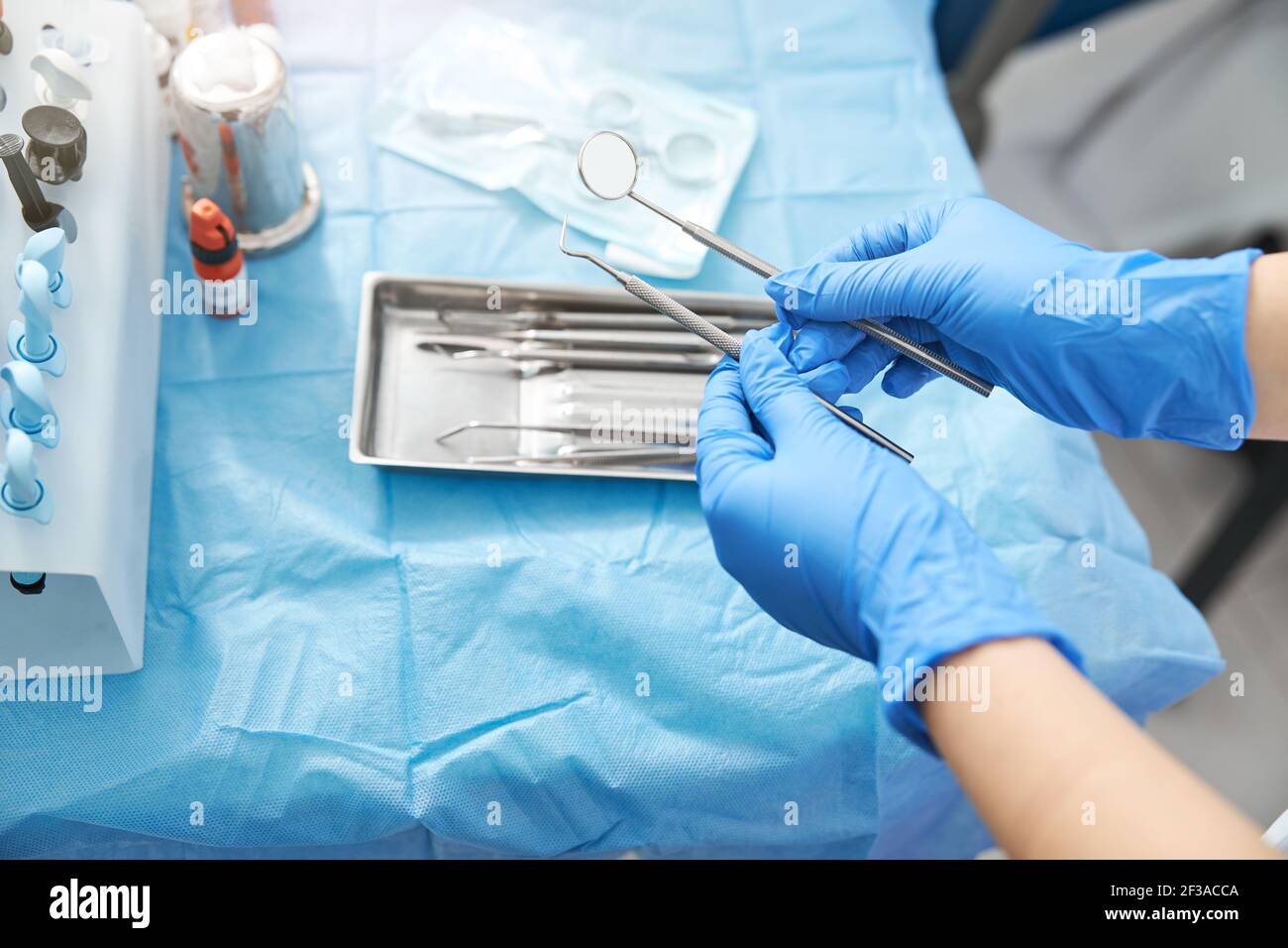 Dental mirror and probe in medical person hands Stock Photo Alamy