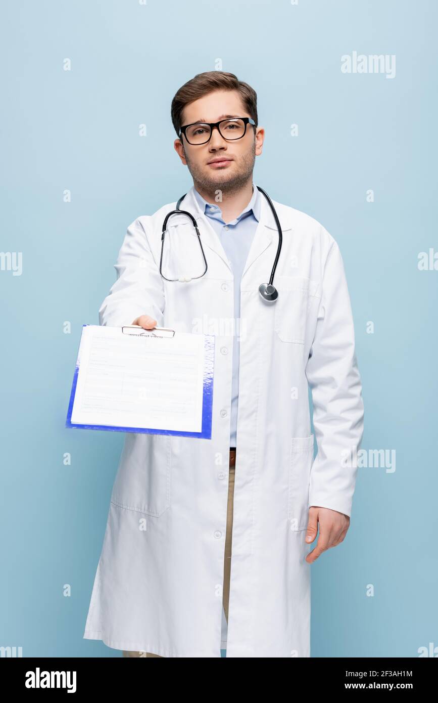 doctor in glasses and white coat giving clipboard with medical card ...