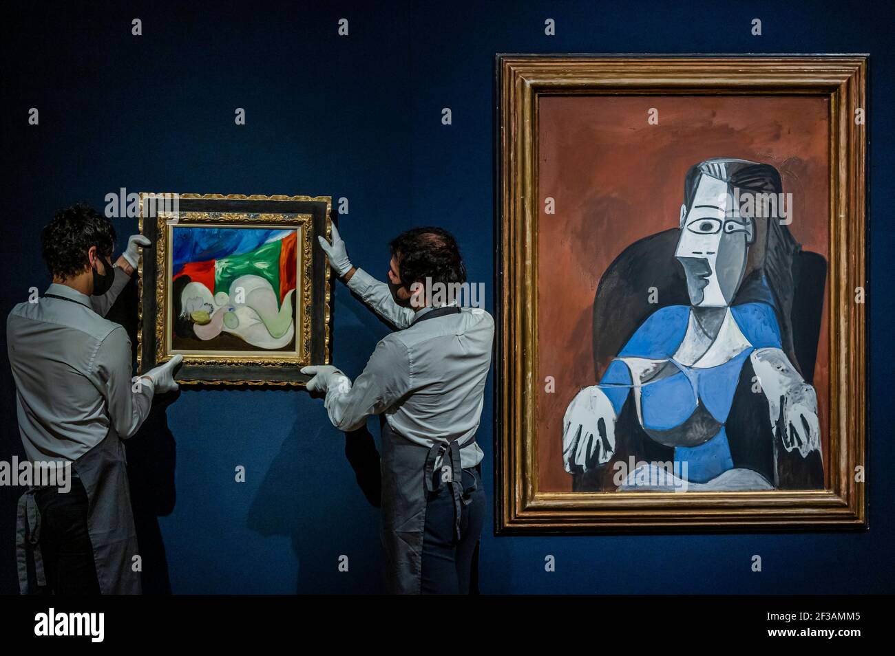 London, UK. 16th Mar, 2021. Pablo Picasso, Femme nue couchée au collier (Marie-Thérèse), Painted in Boisgeloup on 18 June 1932, Estimate : £9,000,000-15,000,000 with his Femme assise dans un fauteuil noir (Jacqueline), Painted in Mougins on 19 November & 18 December 1962, Estimate : £6,000,000-9,000,000 - Behind closed doors: preparations take place at christie's ahead of the livestreamed 20th century art evening sale and the art of the surreal sale on 23 march Credit: Guy Bell/Alamy Live News Stock Photo
