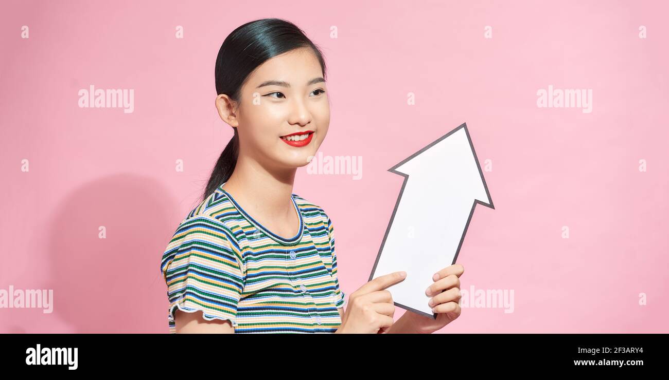 Woman holding big direction arrow hi-res stock photography and images ...