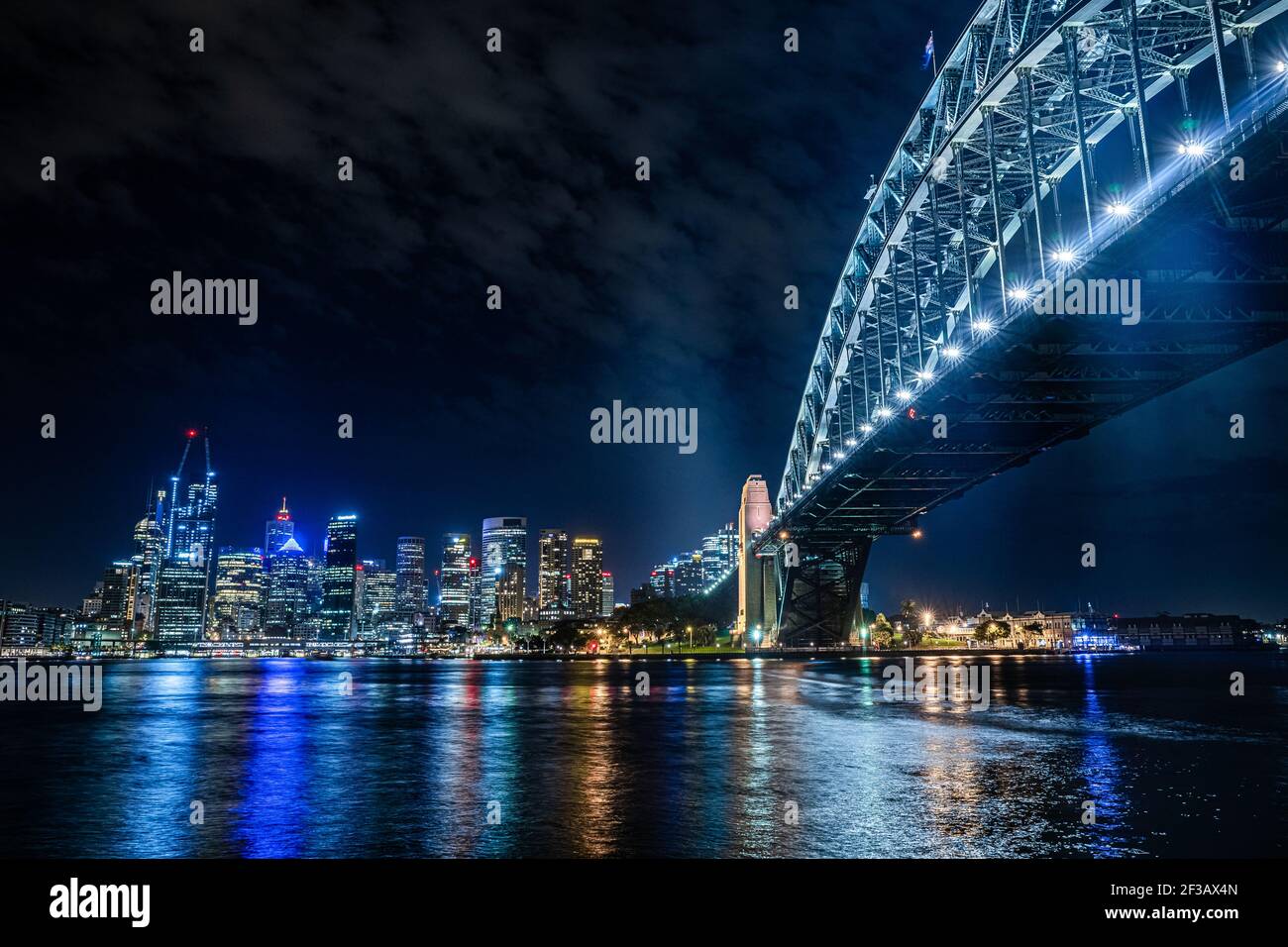 Sydney Harbour Bridge and the Sydney city skyline at night Stock Photo ...