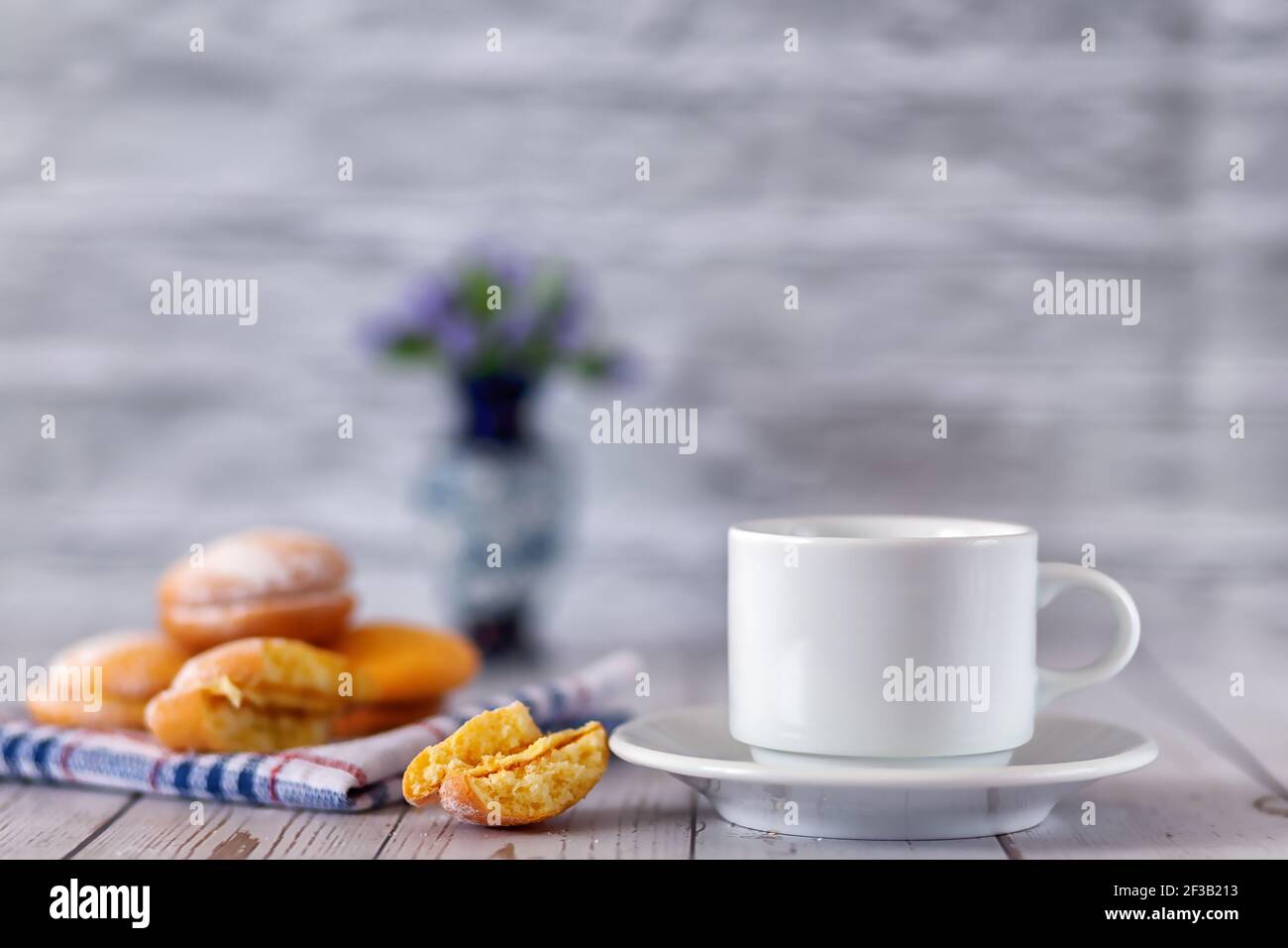 A cup of freshly brewed tea with lemon biscuits. Selective focus. Stock Photo