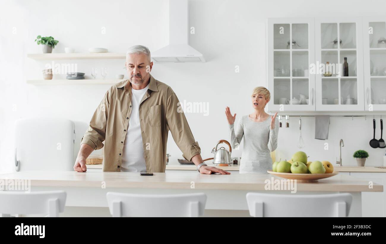 Couple have disagreement at kitchen at home, quarrel in family and problems in relationships Stock Photo