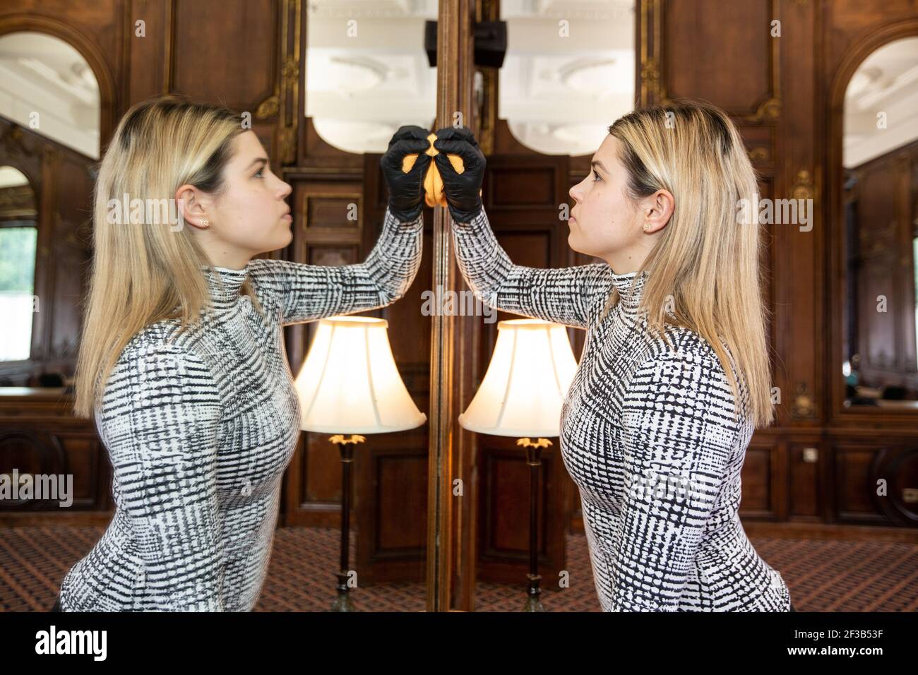 Cleaning of dining room mirrors ahead of 150 Year Anniversary since Napoleon III, French Imperial Family in-exile arrived at Camden Place, Kent, UK Stock Photo