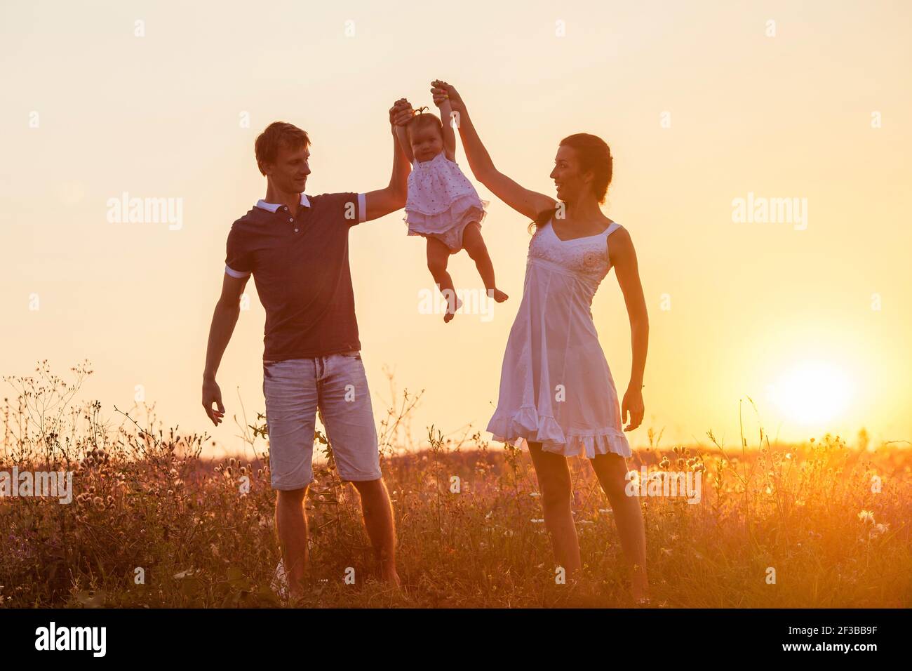 Silhouette of a happy family. Mother, father and child daughter ...